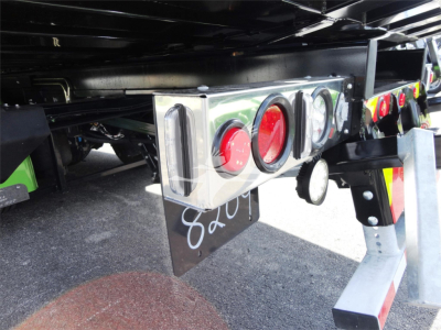 Peterbilt 337 rollback truck rear showing taillights and bumper brackets with reflective tape and mounting hardware.