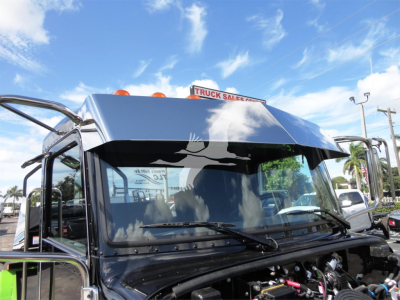 Peterbilt 337 rollback truck front cab with windshield wipers visible, chrome mirrors, and engine bay area in the foreground.