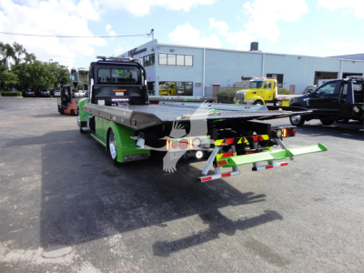 2022 Peterbilt 337 rollback truck rear view showing green accents and rear loading equipment