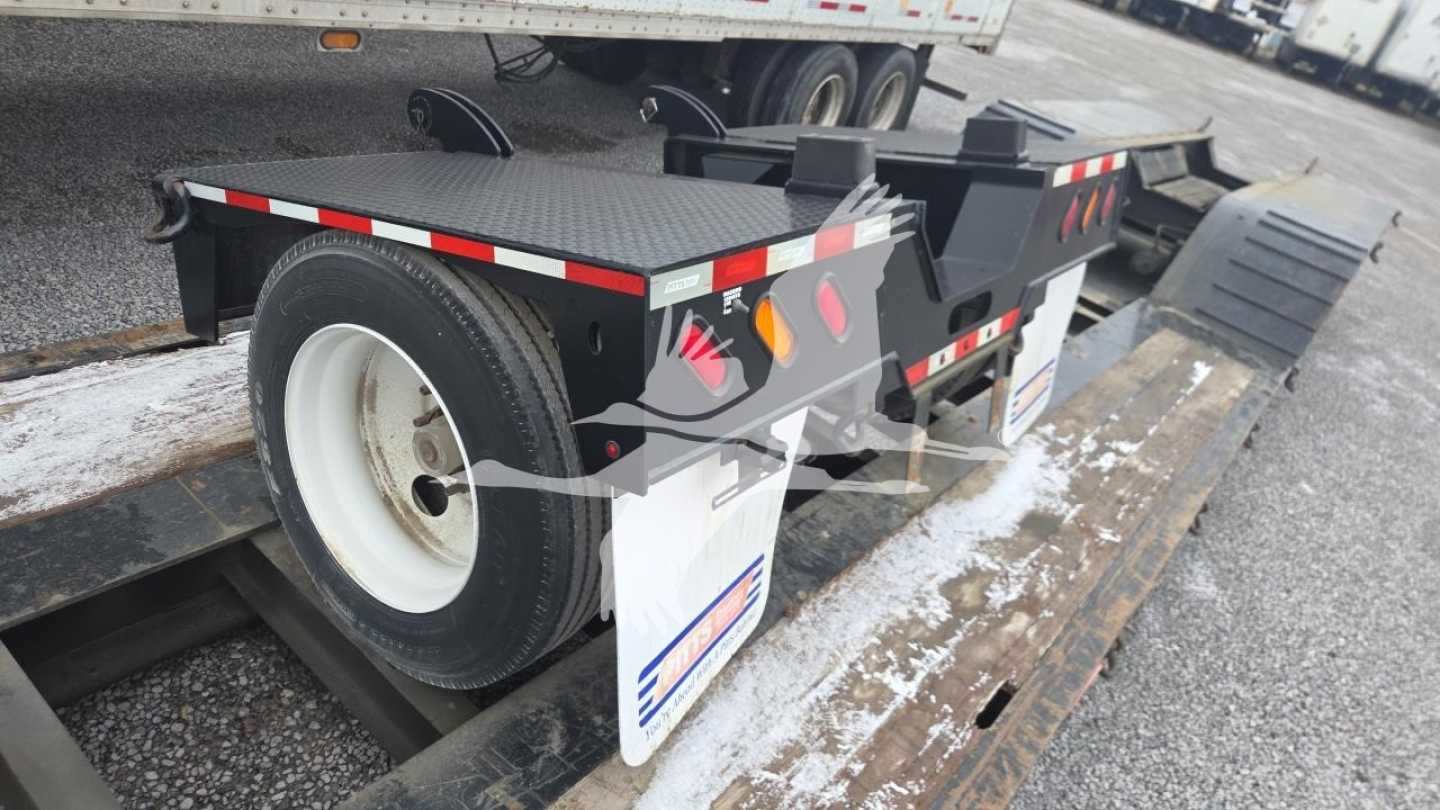 Pitts LB55-18DC lowboy trailer showing side view with spare wheel and ramp extensions.