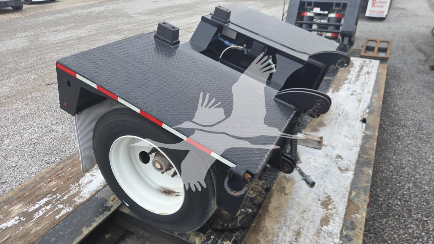 Pitts LB55-18DC lowboy trailer platform with black diamond plate surface, wheel and hydraulic components visible, rear ramps folded, white wheel.