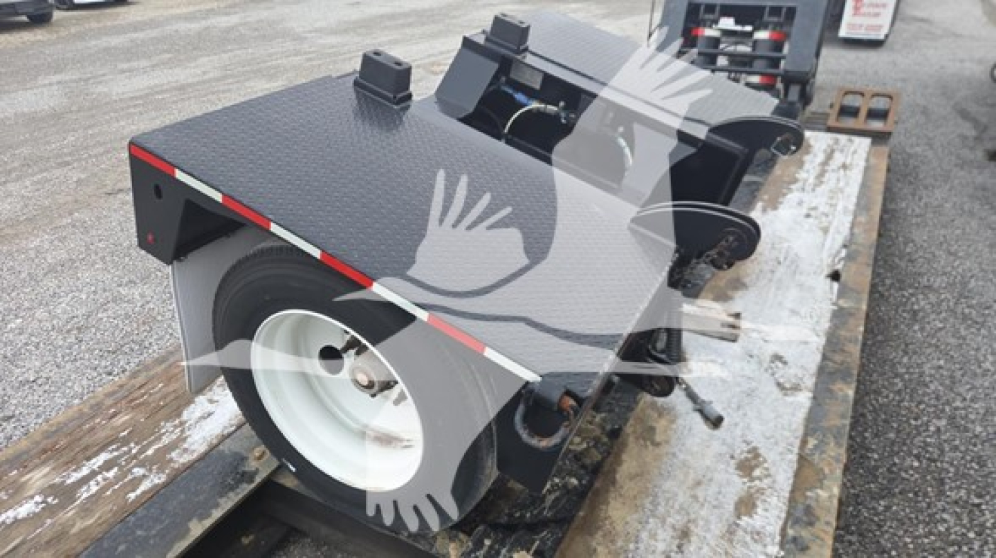 Pitts LB55-18DC lowboy trailer deck and wheel area visible with diamond plate surface and white wheel, side rails, and ramp mechanisms.