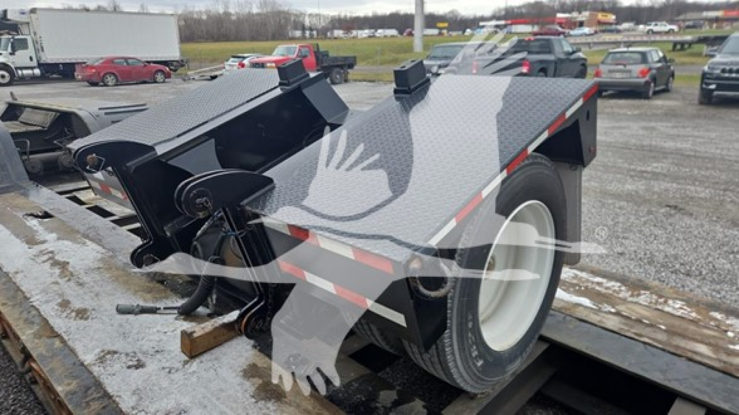 Trailer with a flatbed deck and dual wheel on the right side, black steel frame, visible hydraulic components and a white wheel. No legible branding text visible.