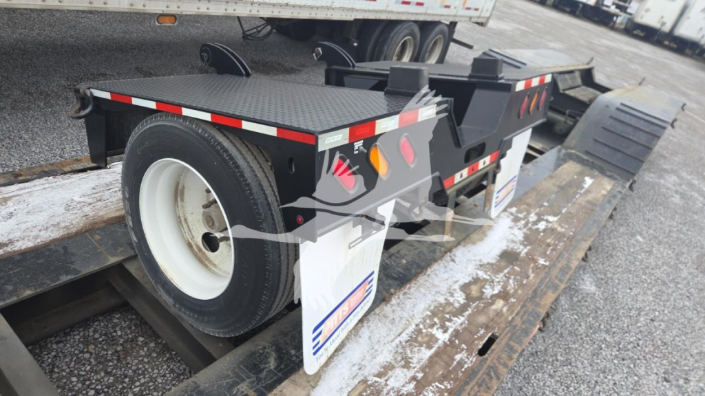 Pitts LB55-18DC lowboy trailer showing side view with spare wheel and ramp extensions.