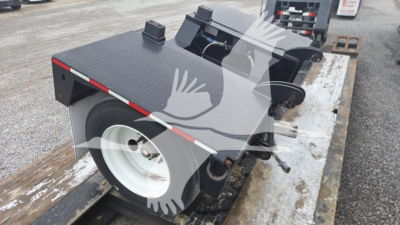 Pitts LB55-18DC lowboy trailer deck and wheel area visible with diamond plate surface and white wheel, side rails, and ramp mechanisms.
