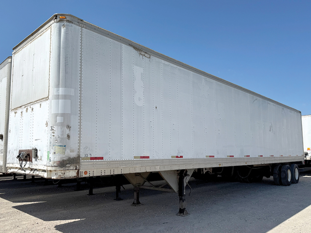 Aluminum trailer with Reefer Trailmobile, side view showing exterior panels and landing gear, stock number 553137, VIN 1XPBDP9X0PD872430.