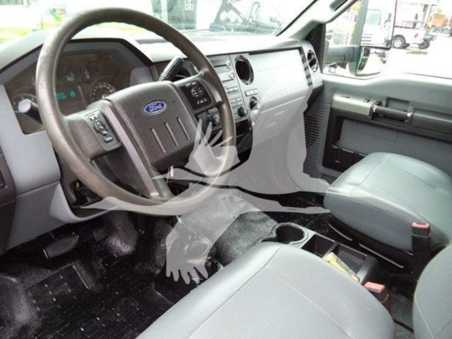 Ford F-650 interior cabin steering wheel and dashboard view showing driver-seat area and center console.