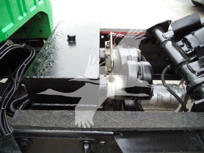 Ford F650 dump truck engine bay showing auxiliary power unit and components with black metal housing