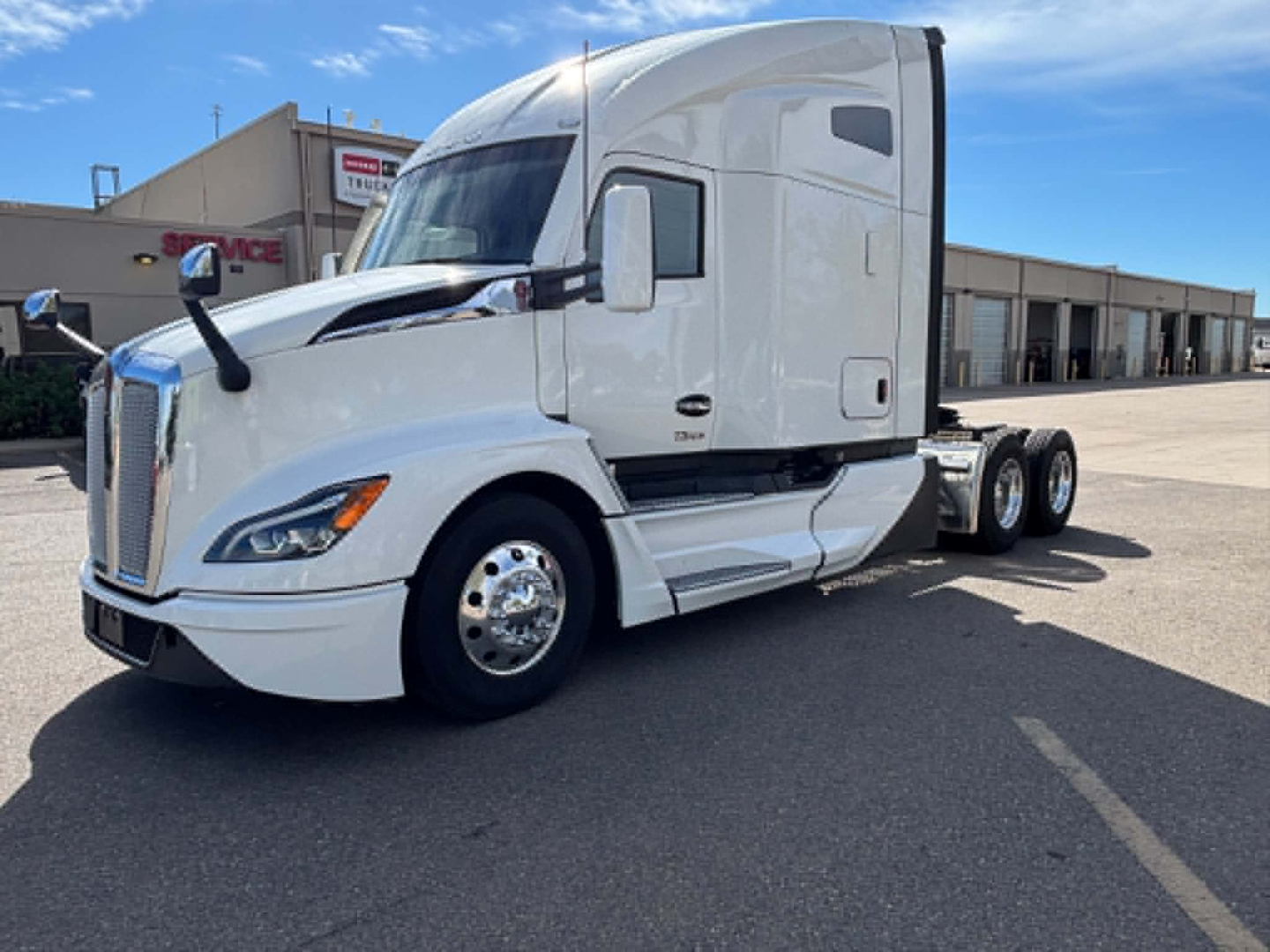 Kenworth T680 tractor unit in white, front-left view.