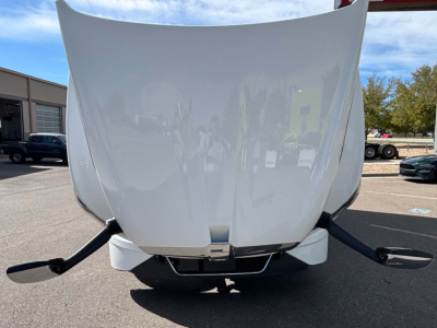 Kenworth T680 hood and front bumper area with open hood and visible engine bay; front view