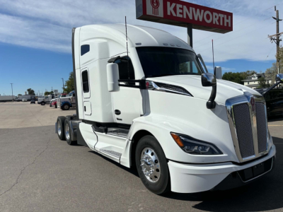 Kenworth T680 sleeper cab truck in white, front-right view, showing grille, headlights, and side mirrors.