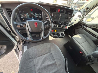 Kenworth T680 truck interior/dashboard view with steering wheel and control panel.