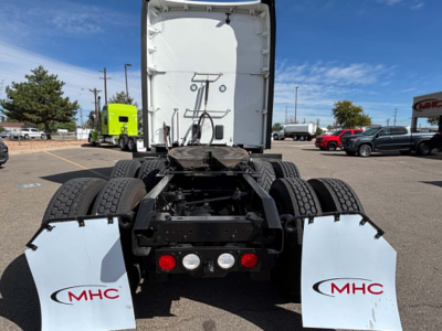 Kenworth truck rear view showing fifth wheel and dual rear axles with white MHC mud flaps.
