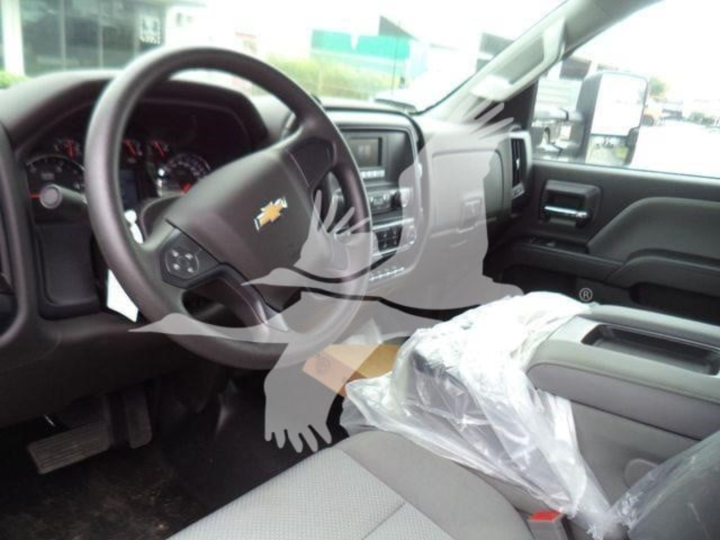 Interior of 2023 Chevrolet Silverado 6500HD with steering wheel and front seats visible.