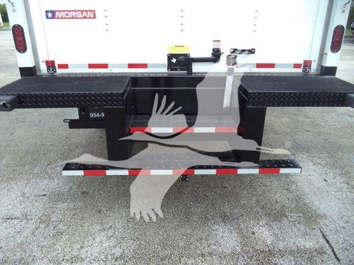 Rear view of a white 2023 Chevrolet Silverado 6500HD box truck showing steel rear bumper steps and bumper with diamond plate pattern.
