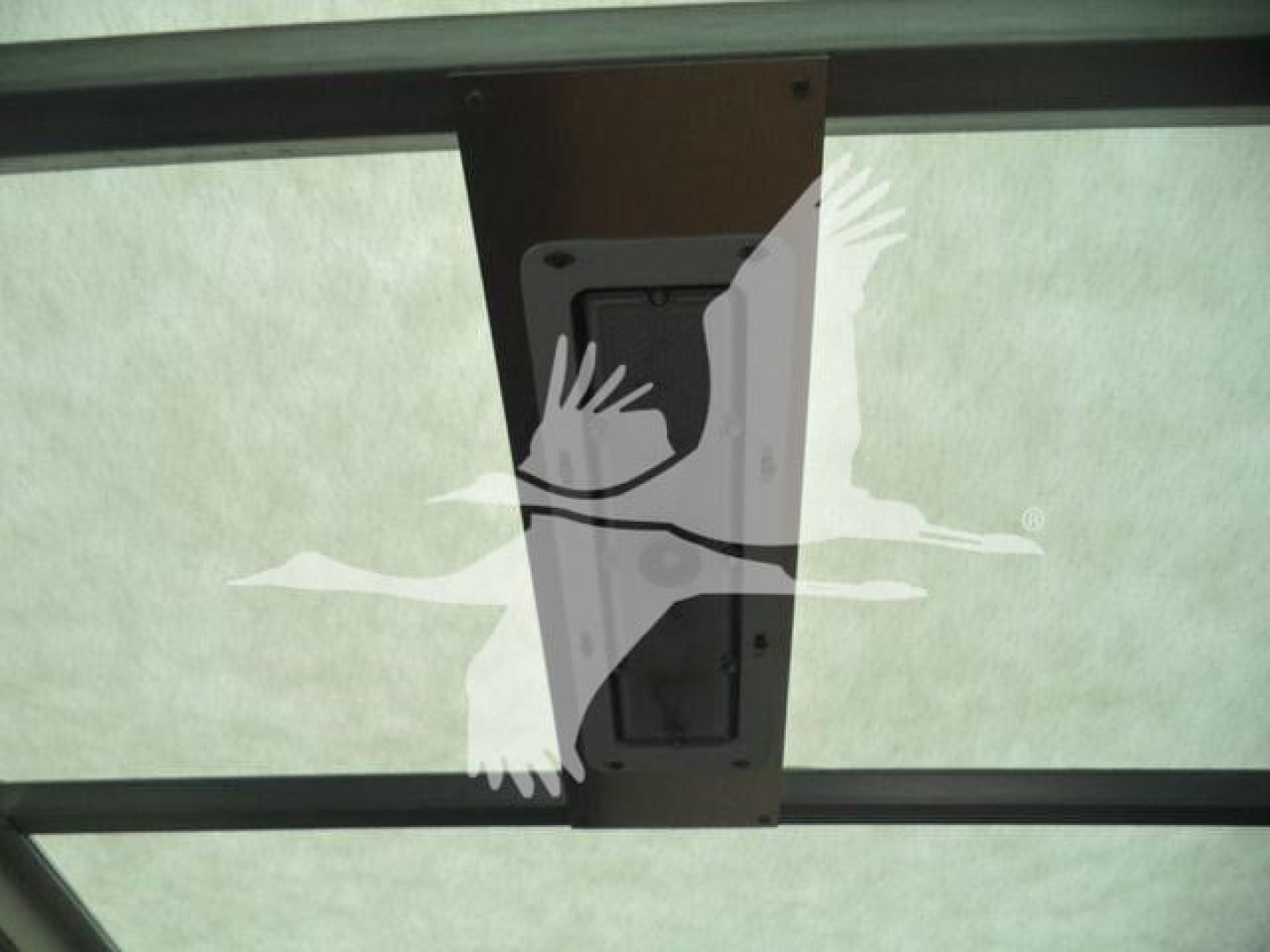 Vehicle part label on a 2023 Chevrolet Silverado 6500HD box truck showing a recessed access panel with mounting screws.