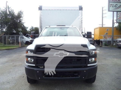 Front view of a white 2023 Chevrolet Silverado 6500HD box truck showing prominent grille with Chevy emblem and large windshield.