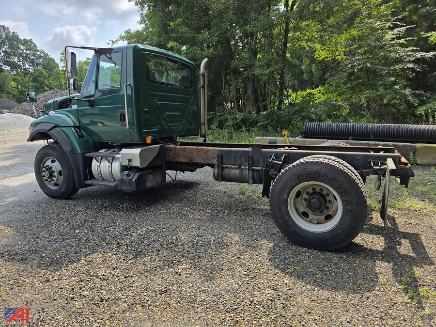 Green 2017 International WorkStar 7500 cab and chassis side view with long wheelbase, dual rear tires, and exposed frame; cab features green paint and chrome exhaust stack