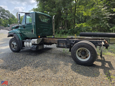 Green 2017 International WorkStar 7500 cab and chassis side view with long wheelbase, dual rear tires, and exposed frame; cab features green paint and chrome exhaust stack