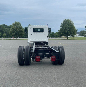 Truck chassis rear view showing dual rear axles and chassis frame.