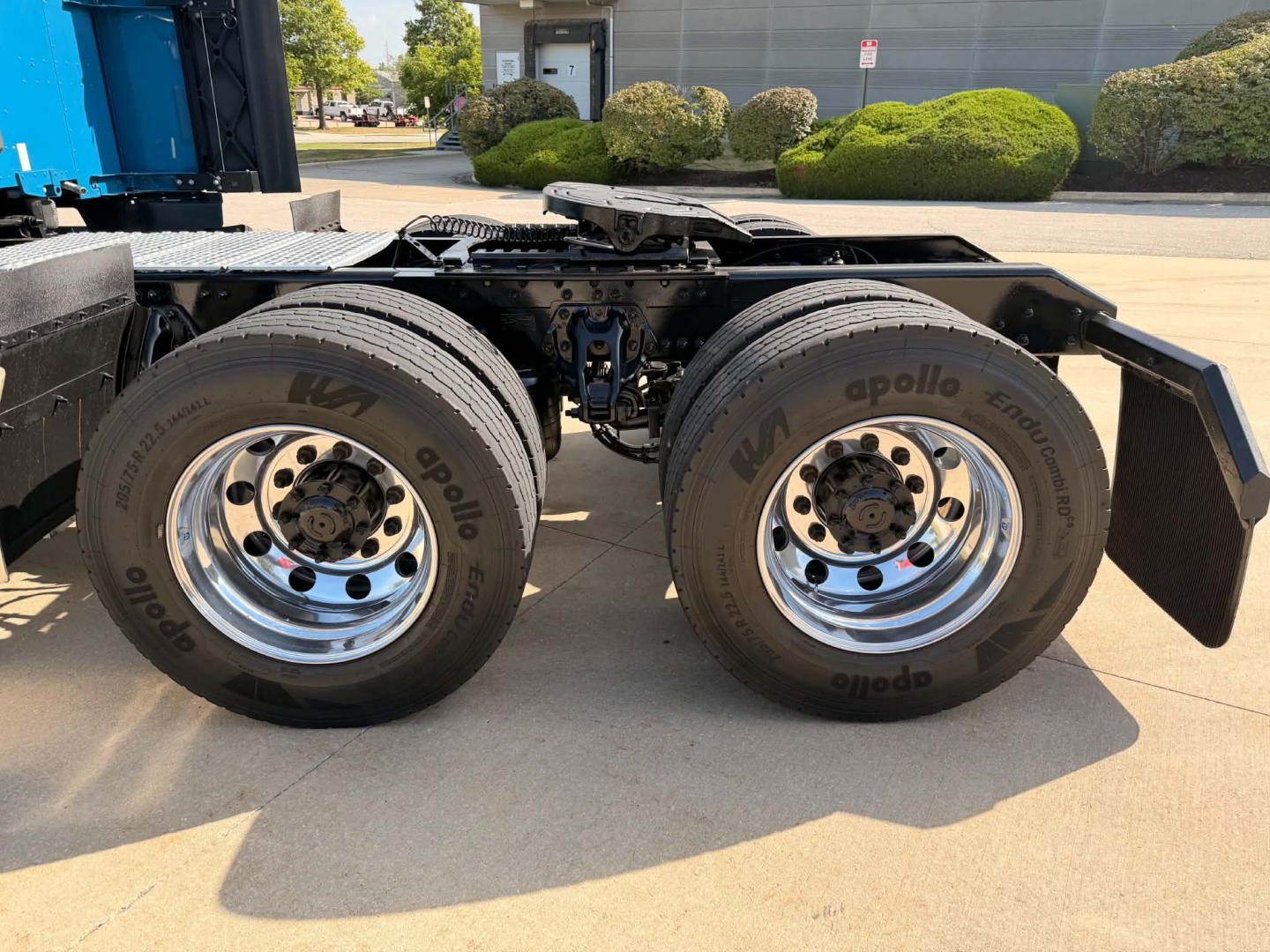 Kenworth T680 rear axle area showing dual rear wheels with Apollo Endeavor tires and chrome wheels.