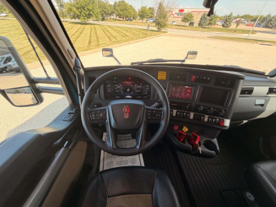 Kenworth T680 dashboard and steering wheel interior showing instrument cluster, center touchscreen, and controls.