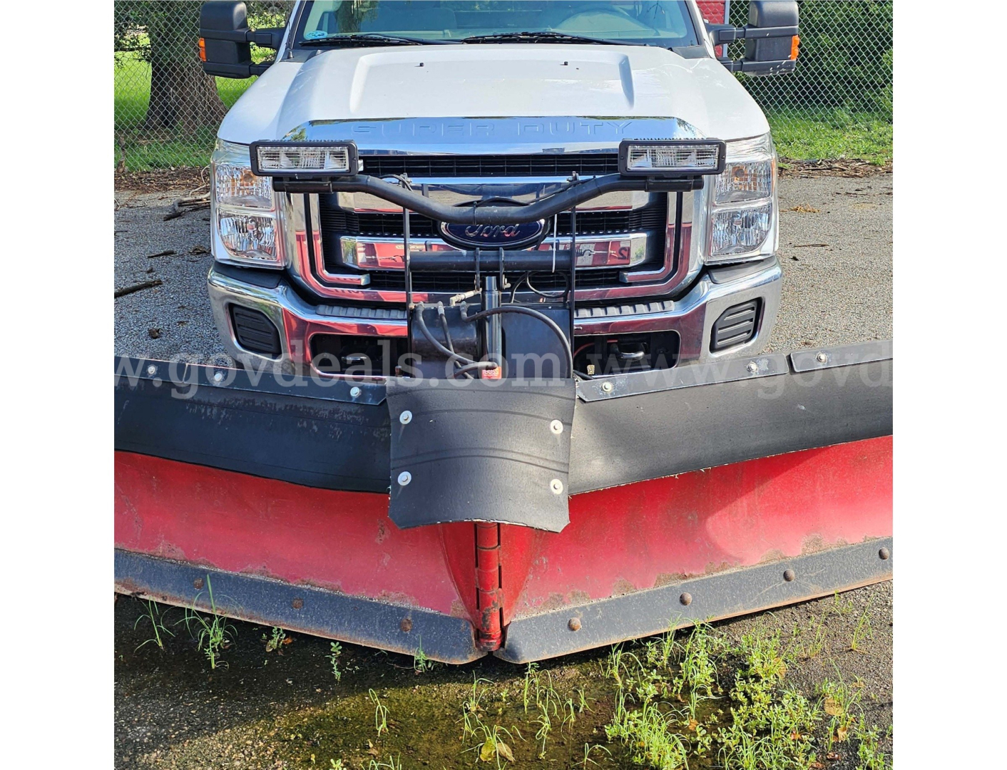 Ford F-350 front view with snow plow attachment showing grille, headlights, and bumper.