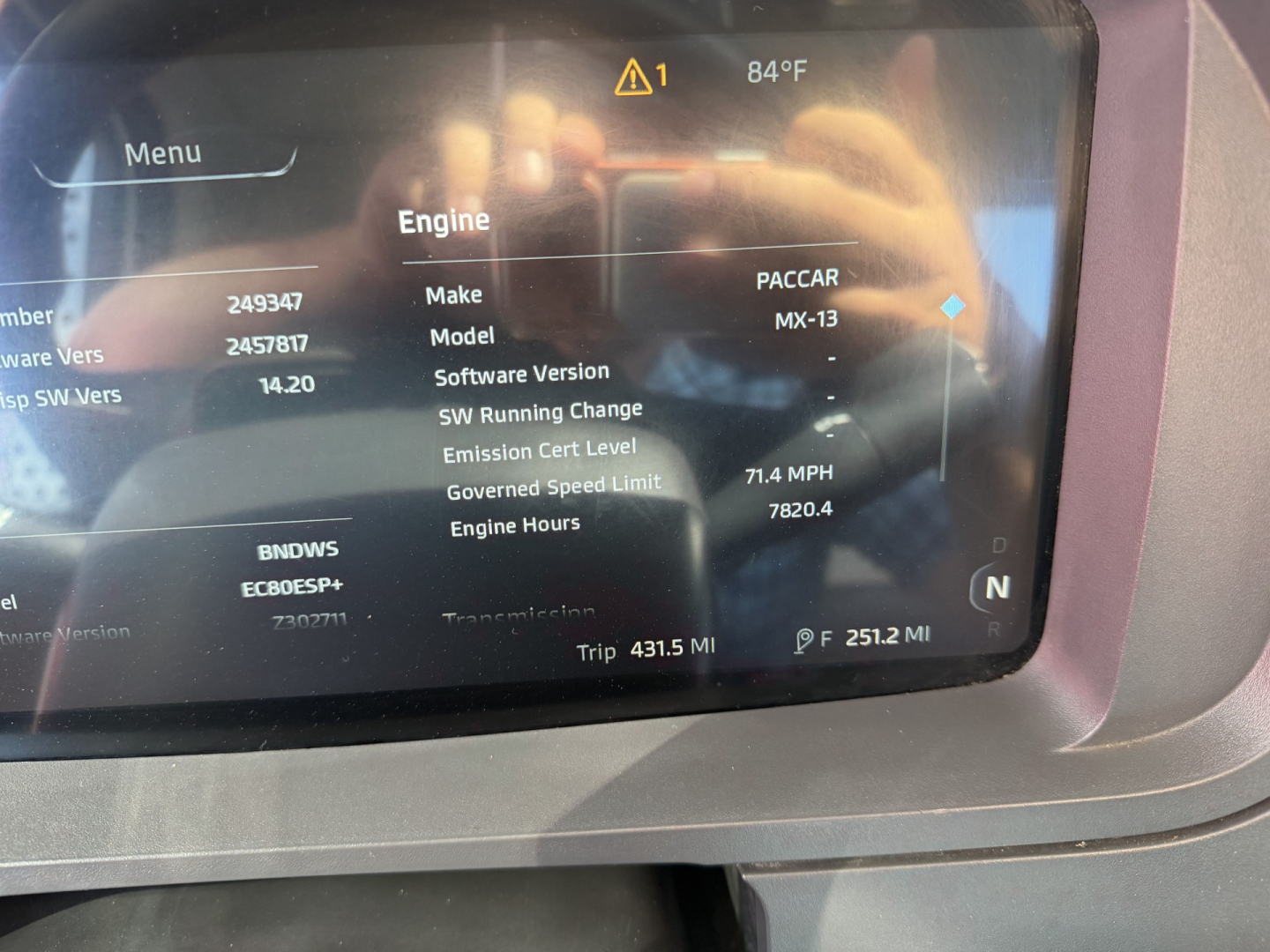 Kenworth T880 dashboard display showing engine information: Make PACCAR, Model MX-13, software SW running version 14.20, emission cert level, governed speed limit, trip 431.5 mi, 251.2 mi trip? and MPG/MPH values.