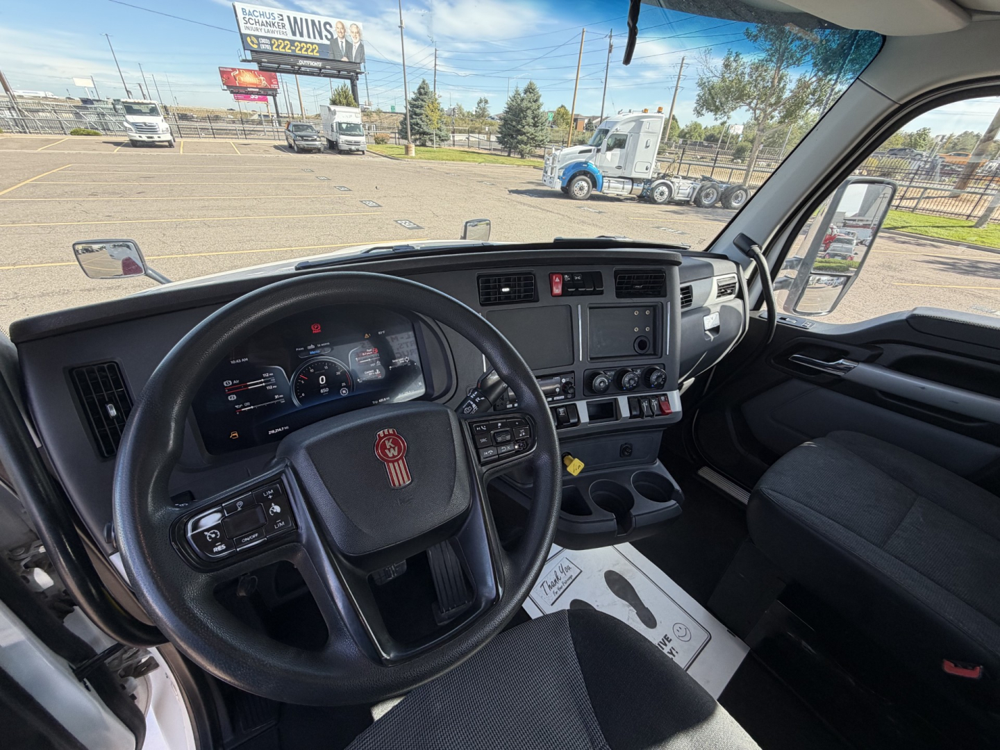 Kenworth T880 interior view showing steering wheel and dashboard from driver seat.