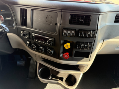 Peterbilt 579 dashboard area showing switches, vents, and cupholders.