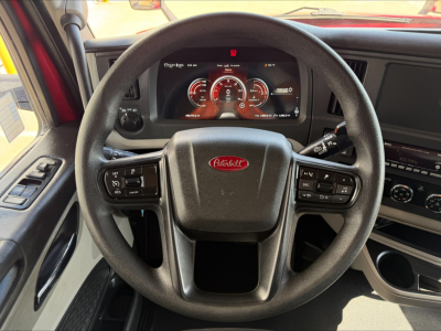 Peterbilt 579 interior steering wheel and dashboard with digital gauges visible.