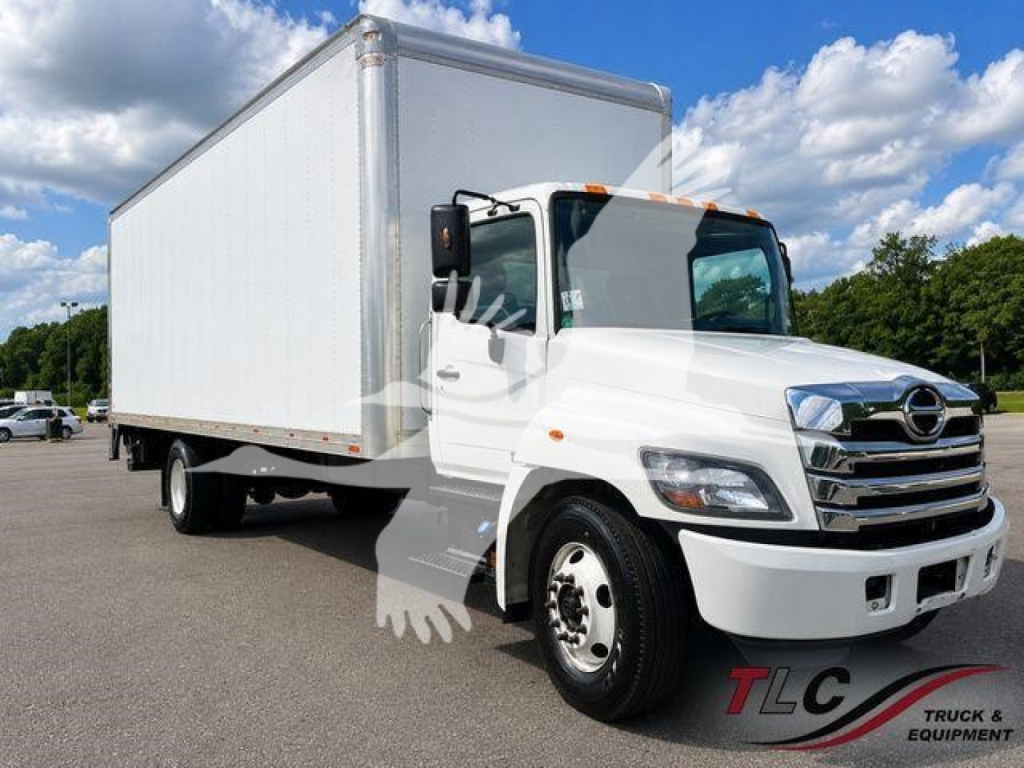 Box truck with 2023 Hino L6 cab and box body showing side view mirrors and front grille.