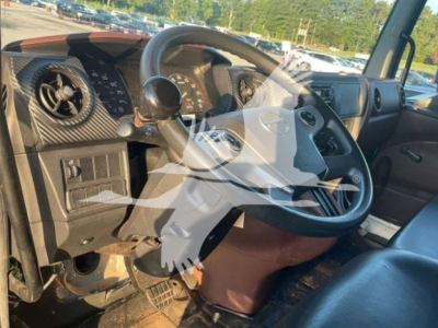 Interior view of a 2023 Hino L6 truck cab showing steering wheel, dashboard with gauges, and driver's seat.