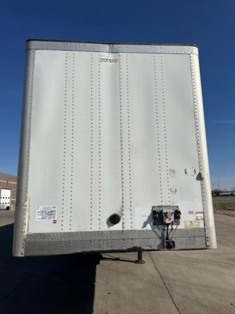 Rear view of a 2013 Wabash van trailer showing an uninsulated steel back door with latches and hitch components.