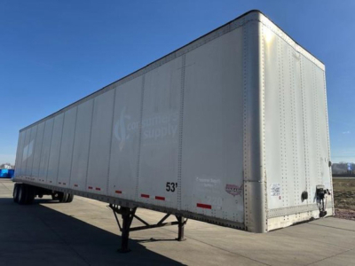 Semi trailer van with silver exterior showing 53' length markings and rear hitch. Faint logos and text on side.