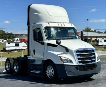 White Freightliner Cascadia 126 day cab tractor shown from front-left angle with sleeper cab top, chrome grille, and dual rear axles.