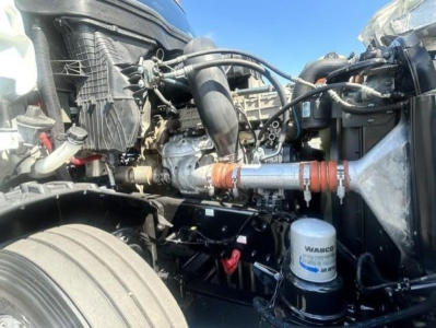 Freightliner Cascadia 126 engine bay with Turbo piping, hoses, and a visible WABCO air dryer/canister
