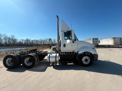 International Prostar tractor with sleeper cab side view showing front grille, exhaust stack, and wheelset.