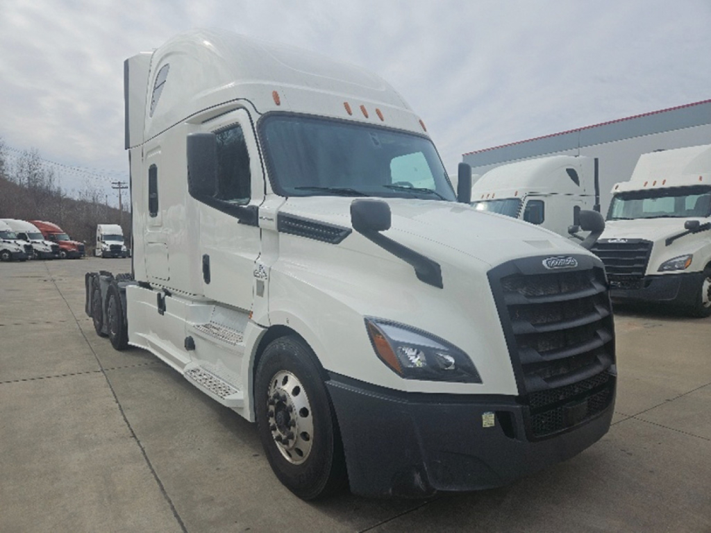 Freightliner Cascadia126 tractor with sleeper cab, front-left angle. Visible text includes Freightliner emblem on grille and reflective markers; no legible model stickers; truck body is white.