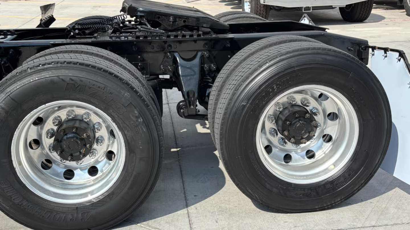 International LT625 tractor truck dual rear wheels showing front drive axles and wheel rims in service condition.