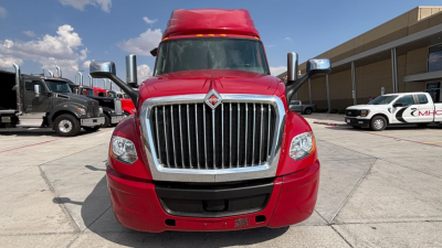 Red 2022 International LT625 highway tractor front view showing large chrome grille and headlights.
