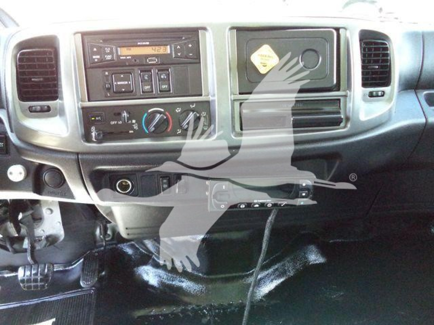 Dashboard view of a 2015 Hino 268A refrigerated truck showing instrument cluster, climate controls, and center console.