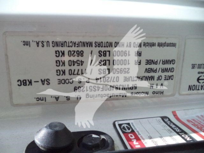 Label sticker on a Hino refrigeration truck showing vehicle data and codes (upside down) with VIN-like numbers and weight specs.
