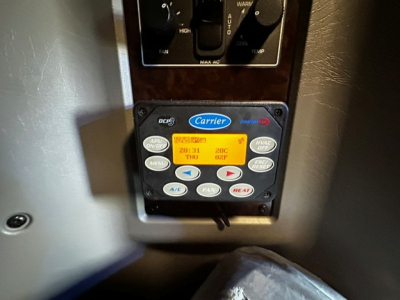 Kenworth W900L dash control panel showing Carrier A/C and dashboard controls.