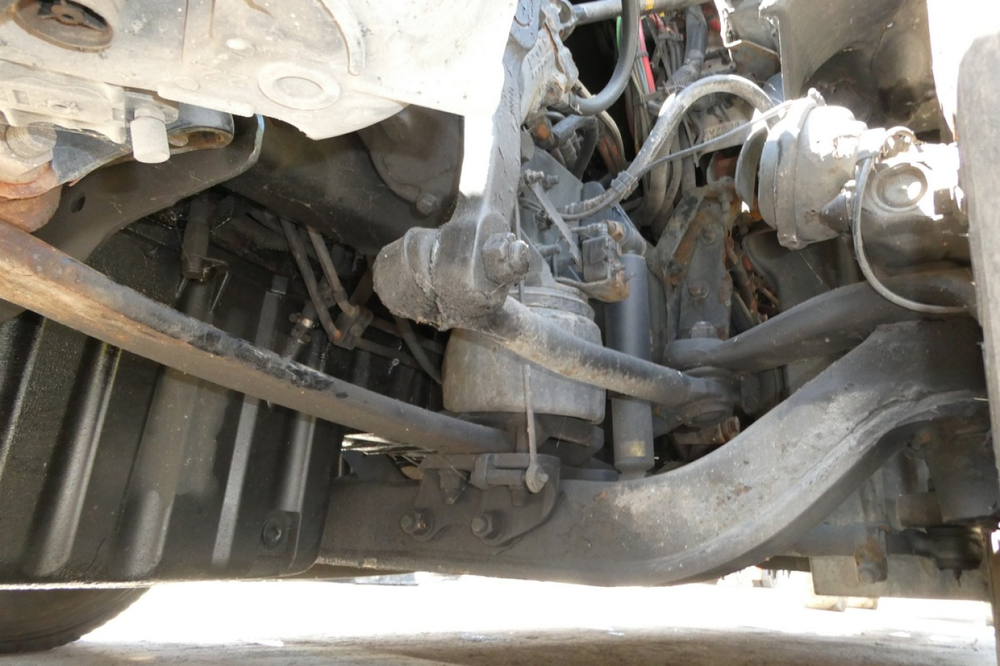 Freightliner Cascadia 125 engine bay/view with frame, hoses, and front suspension components visible.