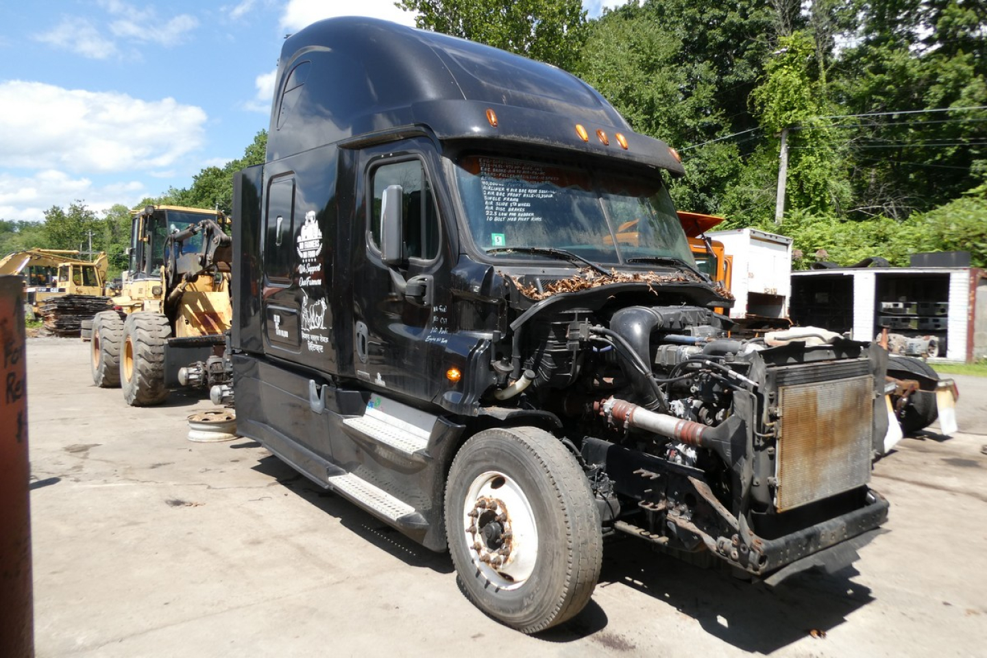 Front view of a 2014 Freightliner Cascadia 125 conventional sleeper truck with front-end damage exposing radiator and engine components.