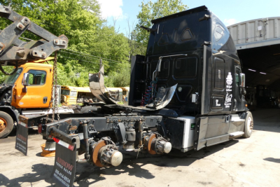 Freightliner Cascadia 125 tractor cab showing chassis with dual rear axles and hub assemblies.