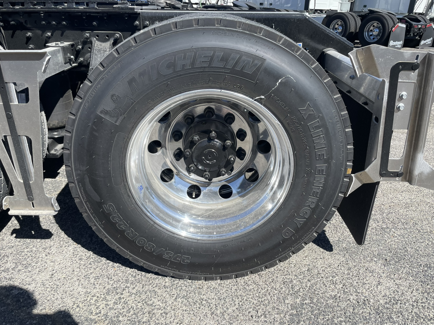 Volvo VNL64T860 wheel and Michelin tire assembly showing tire sidewall; hub and lug nuts visible.