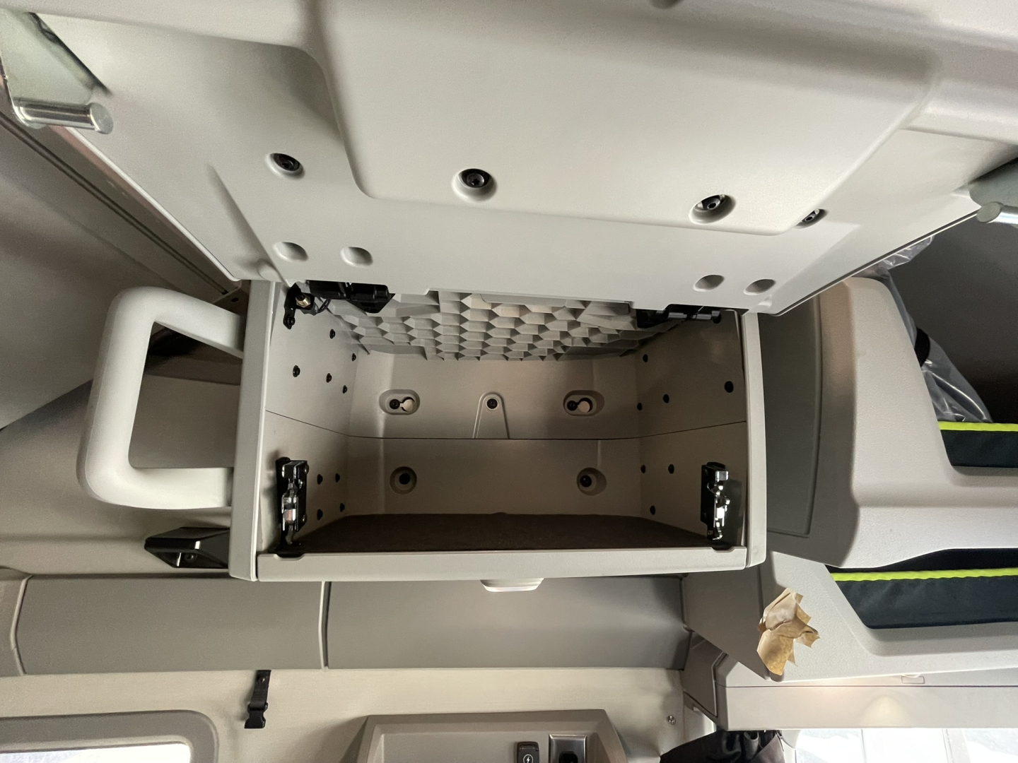 Volvo VNL64T860 cab interior showing empty center console storage drawer and surrounding dashboard panels.