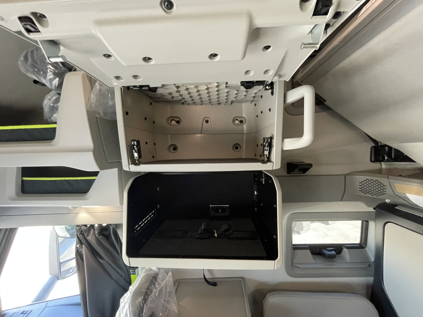 Volvo VNL64T860 sleeper truck cab interior showing under-bunk storage compartment and dashboard area.